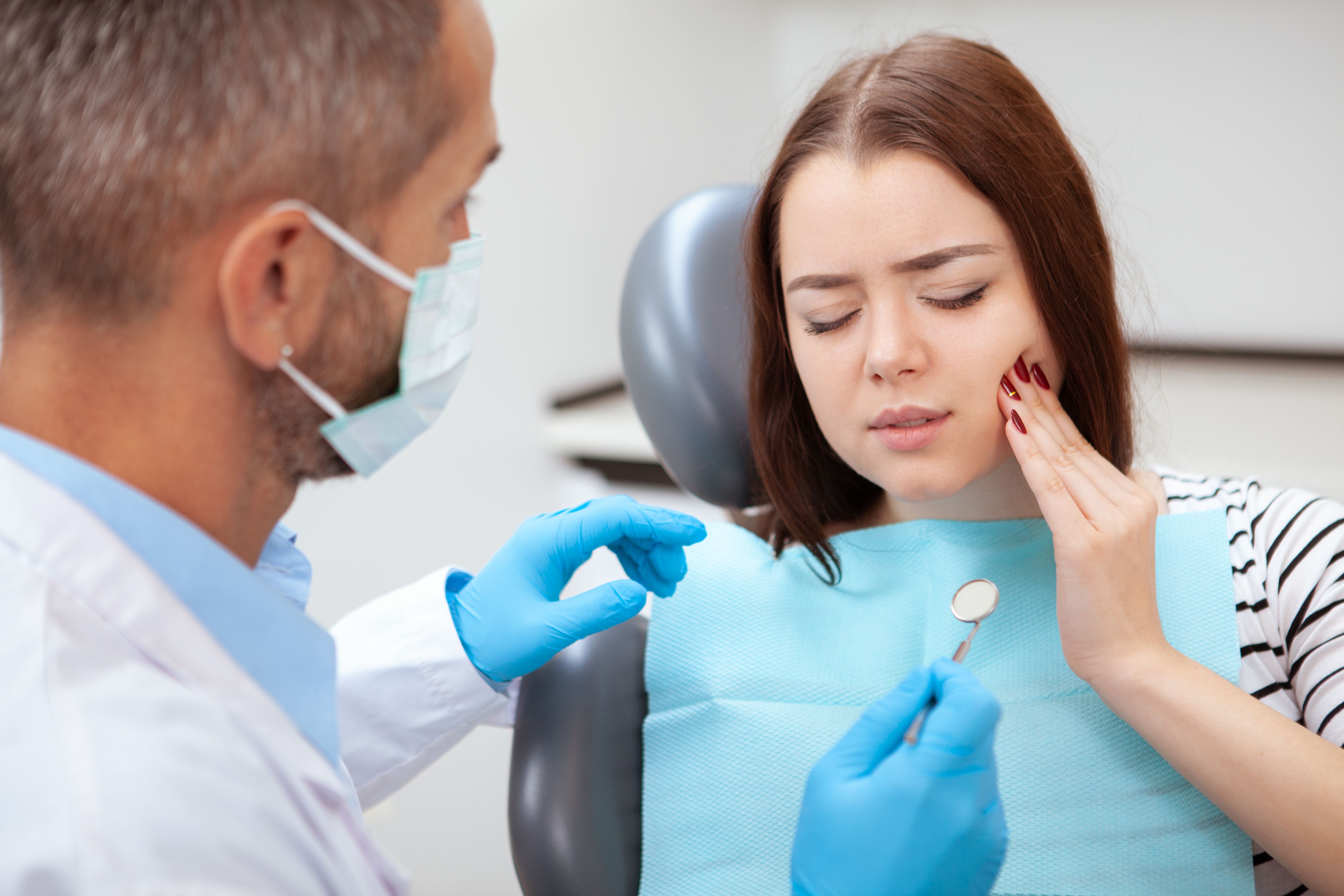 Beautiful young woman visiting dentist for medical checkup