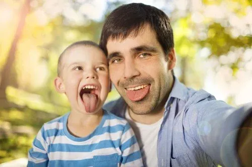 father-and-son-spending-nature-selfies-tongues-out