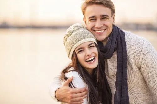 young-couple-smiling-on-beach