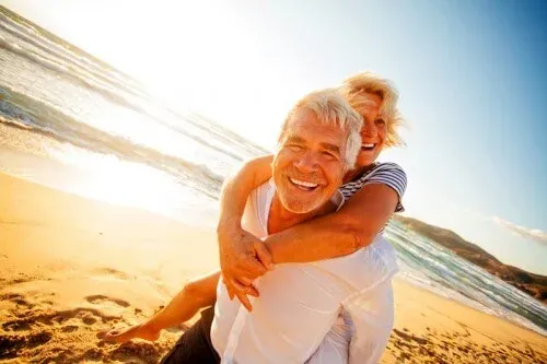 elderly-couple-smiling-beach-web